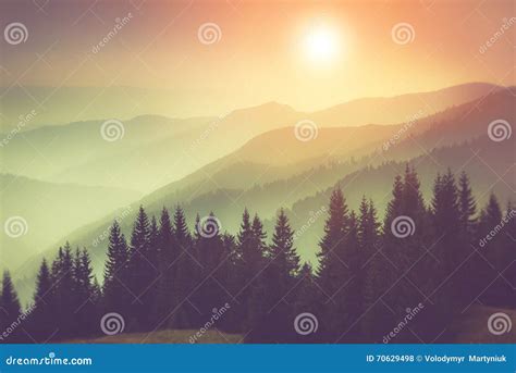 Landscape Of Misty Mountain Hills And Forest Fantastic Evening Glowing
