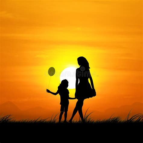 The Silhouette Of A Mother And Daughter During Sunset Stock Photo