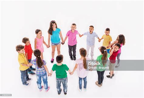 Large Group Of Happy Children Playing Ringaroundtherosy Stock Photo
