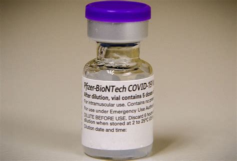 Some vials of pfizer inc. What Will The COVID-19 Vaccine Cost Me? | The Well by ...