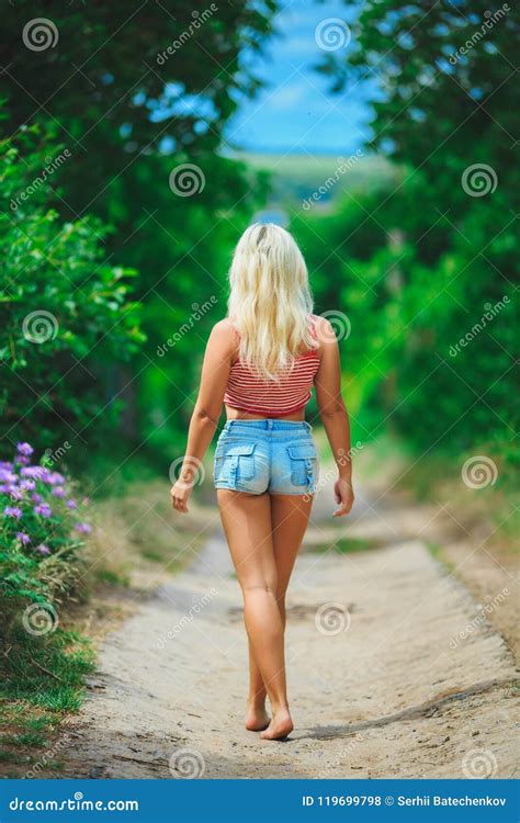 Back View Of Walking Woman Beautiful Blonde Girl In Motion B Royalty
