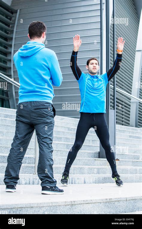 Male Runners Stretching And Warming Up Together Stock Photo Alamy