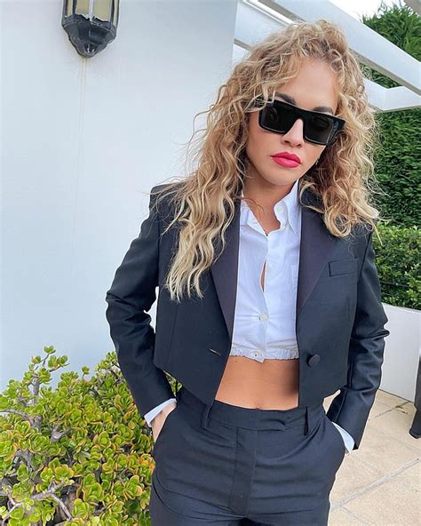 rita ora shows off her washboard abs in a cropped shirt and blazer