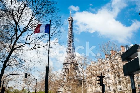 Eiffel Tower In Paris With French Flag Stock Photos