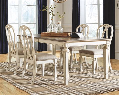 Realyn Chipped White 5 Pc Rect Drm Ext Table And 4 Uph Side Chairs