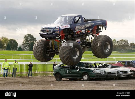Monster Truck Jumping Crushed Cars In A Race Stock Photo Royalty Free