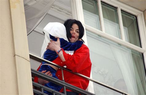 Michael Jackson Dangles Baby