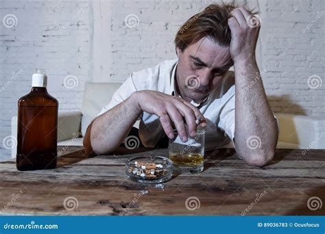 Depressed Alcoholic Businessman With Loose Necktie Wasted And Drunk