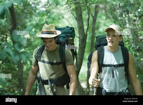 Two Hikers Walking Through Forest Stock Photo Alamy