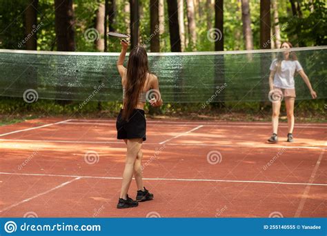 Badminton Player On Badminton Court Two Girls Play In The Park In