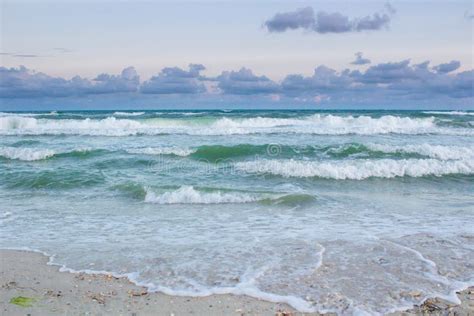 Sea Coastal Waves Rolling On Sandy Beach Cloudy Sunrise Stock Photo