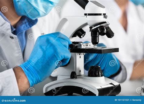 Male Scientist With Microscope Working In Laboratory Closeup Stock