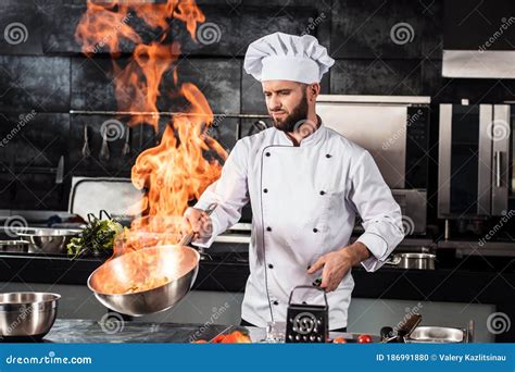 Chef Cook Food With Fire At Kitchen Restaurant Cook With Wok At Kitchen Stock Photo Image Of