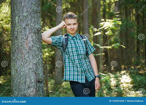 Teenager Boy Walking In The Forest Alone In The Summer Day Stock Photo