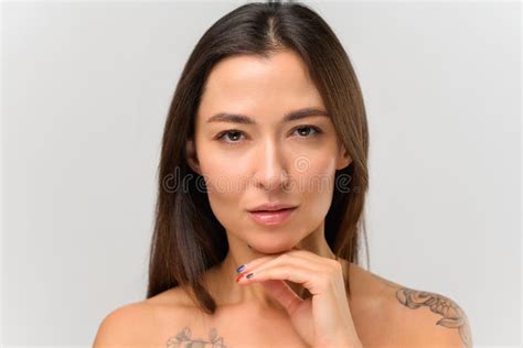 Portrait Of Young Asian Woman With Tattoos At Her Shoulders At Studio