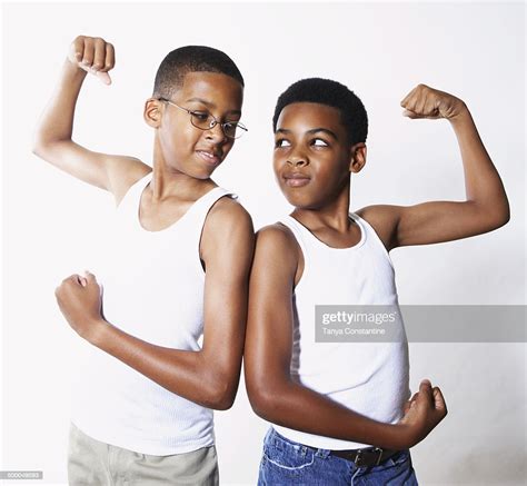 Mixed Race Boys Flexing Their Muscles Photo Getty Images