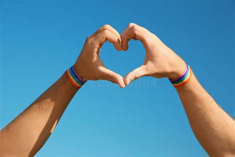 gay couple making heart shape with their hands stock image image of blue love 131007851