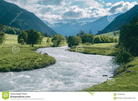 Highland River Landscape With Snowy Mountain Peaks And
