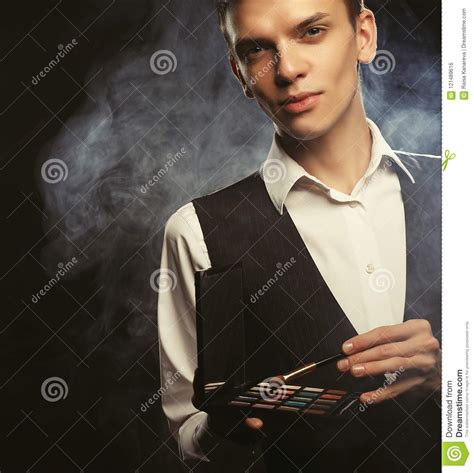 Professional Makeup Artist Posing In Studio Holds A Palette Of Shadows