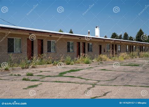 Old Abandoned Seedy Motorcourt Style Motel Decays In The Sun Weeds