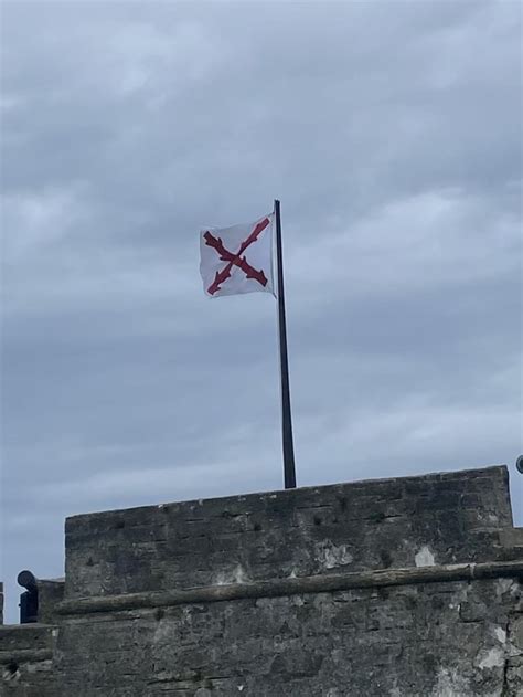 Oc The Burgundy Cross Flying Above The Castillo De San Marcos In St