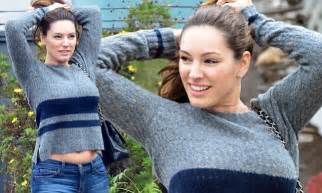 Kelly Brook Flashes A Hint Of Her Toned Tum As Her Jumper Rides Up