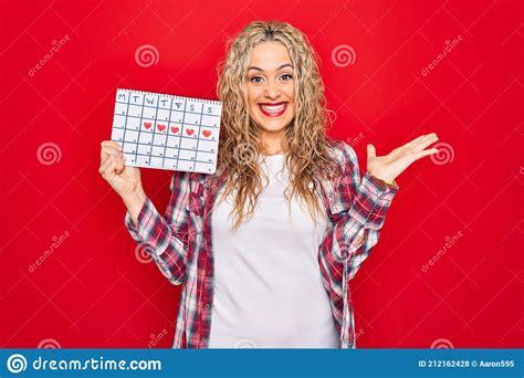 Young Beautiful Blonde Woman Holding Period Calendar Controlling