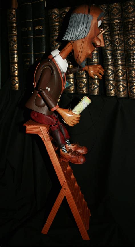 A Carved Colin Godber Marionette Occasionally The Bookworm Climbs Up The Library Steps Then