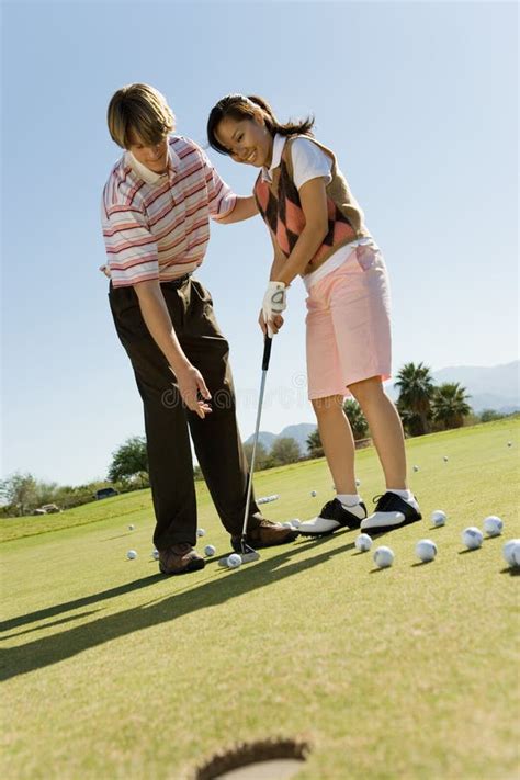 Man Teaching Woman To Play Golf Stock Photo Image Of Adult Cloud