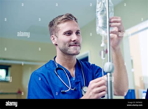 Doctor Checking Intravenous Drip In Hospital Stock Photo Alamy
