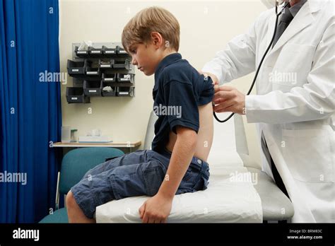 Doctor Examining Young Boy Stock Photo Alamy