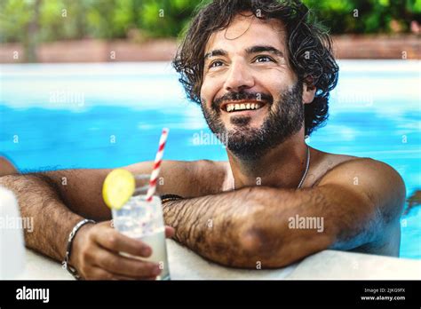 Portrait Of A Hairy Man Relaxing By Drinking A Refreshing Cocktail And