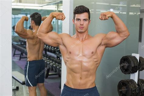 Shirtless Muscular Man Flexing Muscles In Gym Stock Photo By