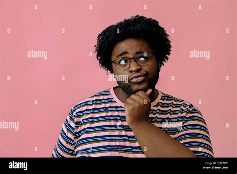 Young Happy African American Man Posing In The Studio Over Pink