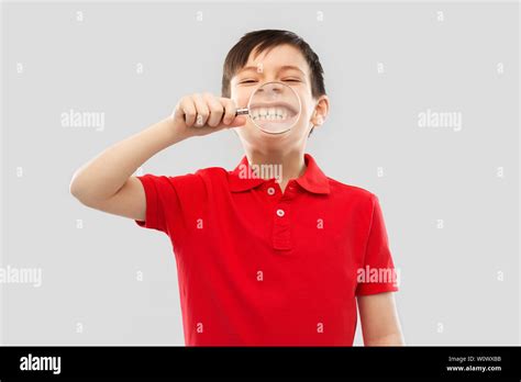 Boy Showing His Teeth Through Magnifying Glass Stock Photo Alamy