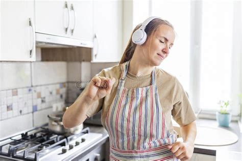 Smiling Beautiful Woman Dancing In Kitchen Listening Music With Headphones Stock Image Image