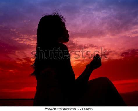 Silhouette Woman Praying During Sunset Stock Photo Edit Now 77113843