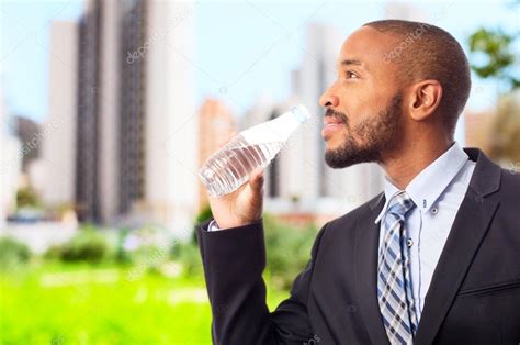Young Cool Black Man Drinking Water — Stock Photo © Kues 65702949