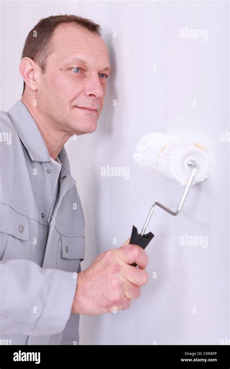 Craftsman Painting A Wall Stock Photo Alamy