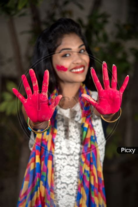 Image Of Young Indian Girl Showing Color Palm Celebrating Holi Tg465016