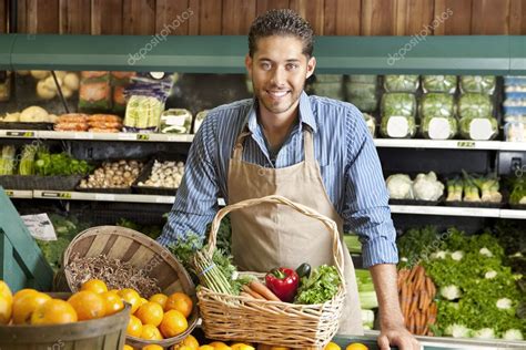 Make life fun tomorrow isnt guaranteed. Portrait of a happy young salesman with vegetable basket in supermarket — Stock Photo ...