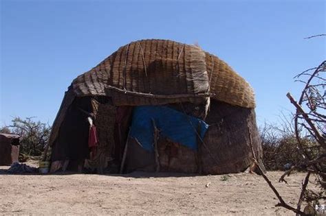 A Hut Made Out Of Sticks And Wood In The Desert