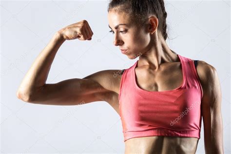 Fitness Girl Showing Biceps Muscles — Stock Photo © Fizkes 119865082