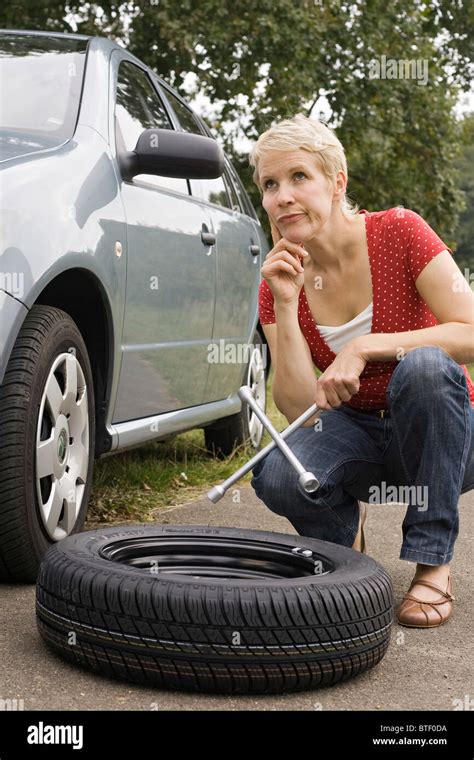 Female Driver Changing Car Tyre Hi Res Stock Photography And Images Alamy