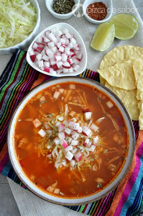 A Bowl Of Mexican Chicken Soup With Tortilla Chips On The Side