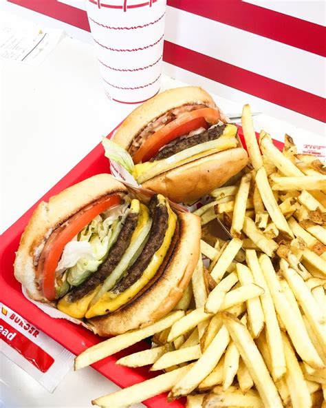Two Hamburgers And Fries On A Red Tray