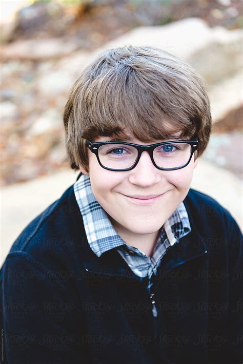 Brown Haired Teen Boy With Glasses Poses For Portrait By