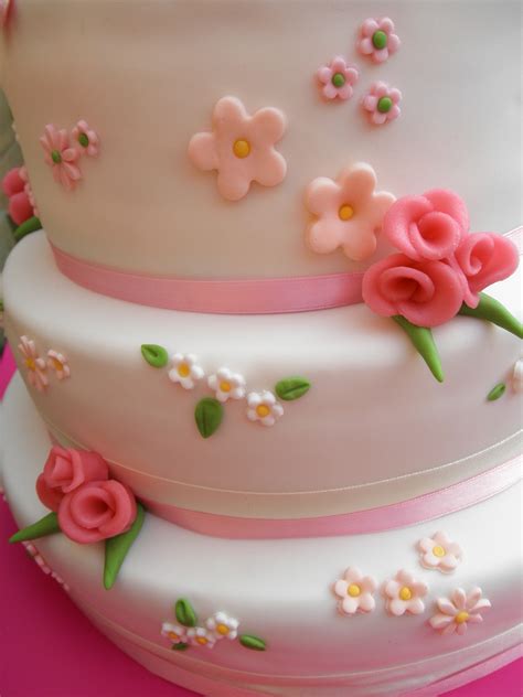 White Wedding Cake With Pastel Colored Flowers