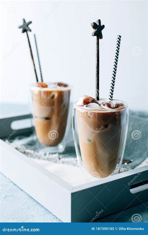 Two Glasses Of Iced Cappuccino Coffee With Ice On Grey Napkins On