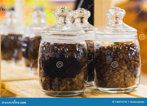 Traditional Black Coffee Beans In A Glass Jar On The Counter Of A Small